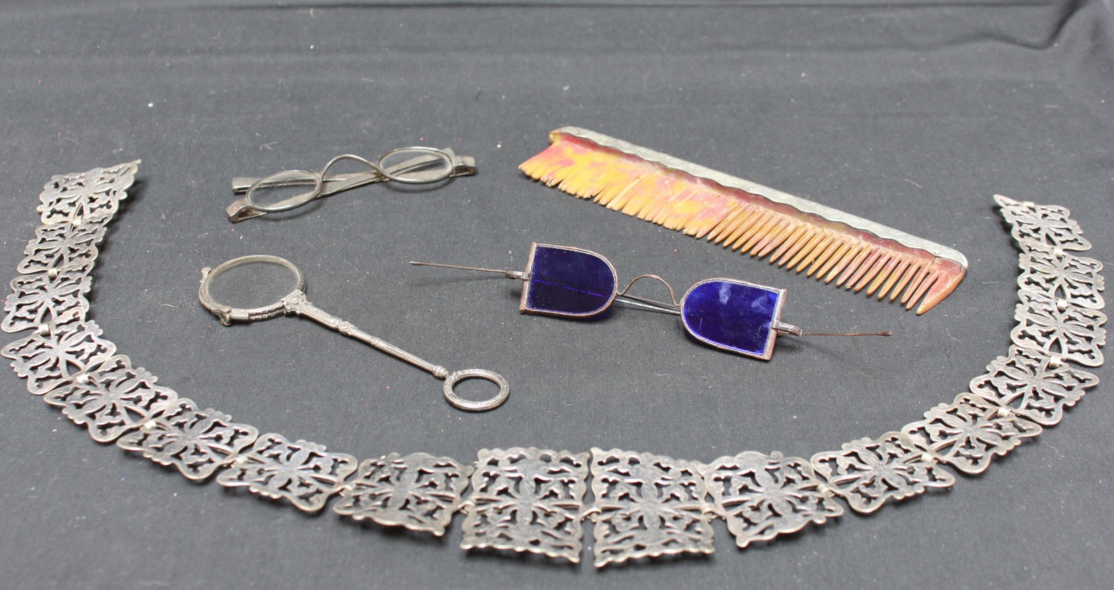 A small group of object’s d'art including a silver plated nurses belt, a silver mounted comb, two
