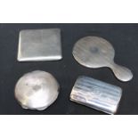Two silver cigarette cases; a silver compact; and a miniature silver hand mirror. Weighable silver