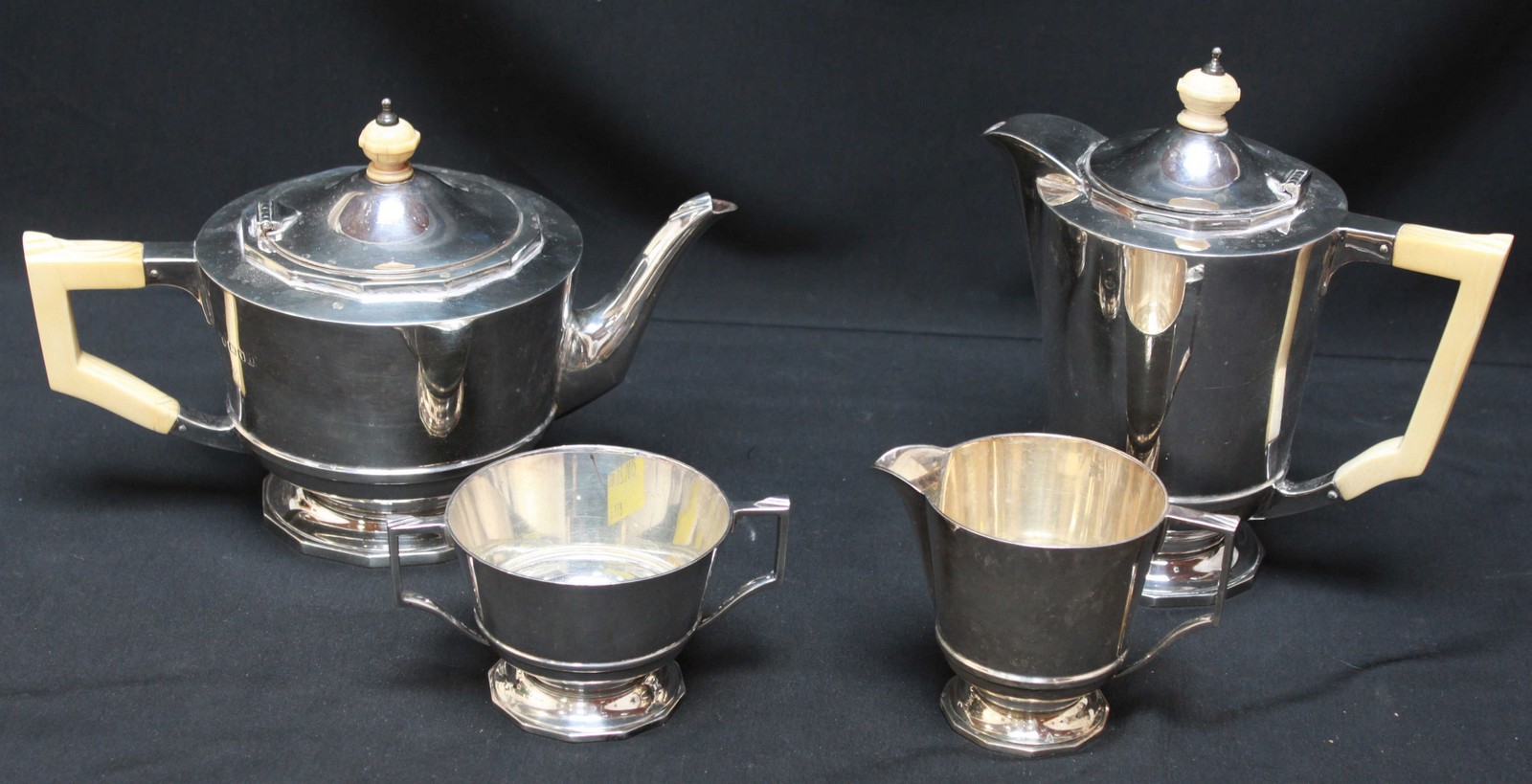 A George V silver and ivory four piece tea set, hallmarked 1933 & 1934, comprising a teapot, hot