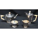 A George V silver and ivory four piece tea set, hallmarked 1933 & 1934, comprising a teapot, hot