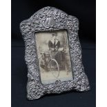 A late Victorian silver embossed photograph frame, hallmarked Birmingham 1901, decorated with