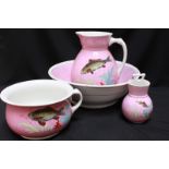 A four-piece pottery dressing table set comprising washbasin, jug, toothbrush pot, chamber pot,