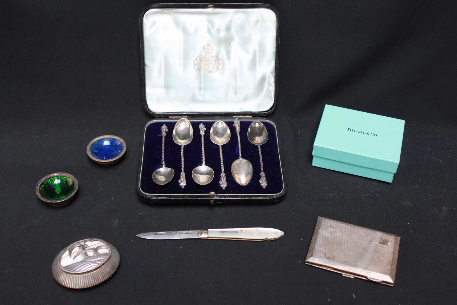 A collection of silver objects including an engine turned cigarette case, a Continental pill box,