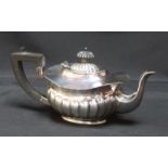 A Victorian semi-fluted silver teapot, hallmarked Chester 1899, of oval form with ebonised knop