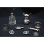 A small collection of silver items including a Police whistle, napkin rings, atomizer, caddy