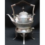An Edwardian silver kettle on stand with spirit burner, half-reeded body and domed cover, ebonised