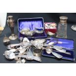 A group of assorted silver items including cased salts, various spoons, a silver topped sugar sifter