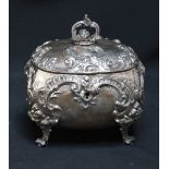 A Victorian Continental white metal embossed box, of cushion shape, finely embossed with scrolls and