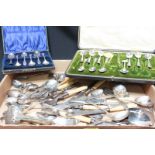 A large collection of mostly silver 19th and 20th century cutlery and two boxed sets of tea spoons.