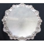 A George II silver salver, the centre engraved with a Coat of Arms, within a shell and scroll border