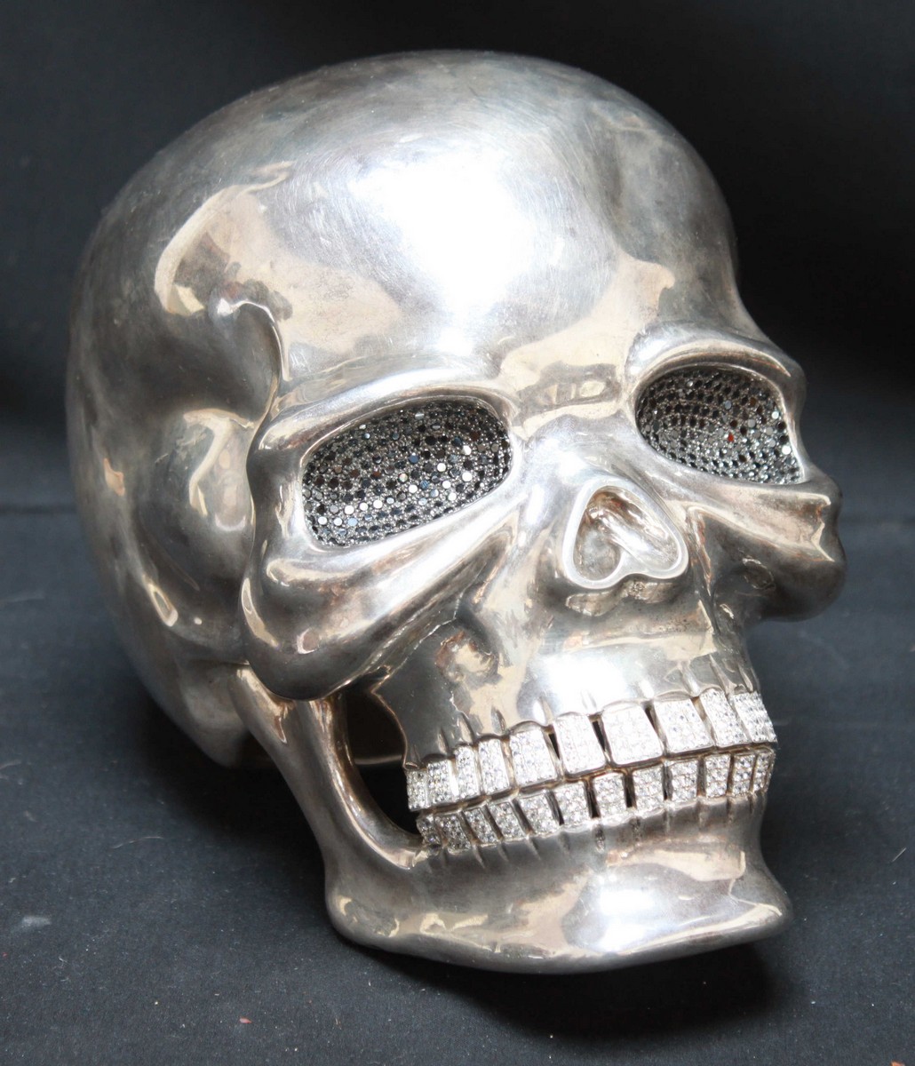A contemporary sterling silver and diamante set life size model of a skull in the manner of Damien