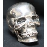 A contemporary sterling silver and diamante set life size model of a skull in the manner of Damien