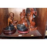 SECTION 51. A shelf of assorted carved hardwood busts from Bali and a collection of turned wooden