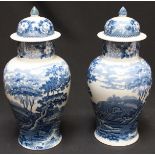 A pair of Victorian Adams pottery blue and white vases and covers, with transfer printed landscape