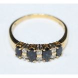 An 18ct gold bridge ring set with four marquise sapphires and six diamonds, the diamonds weighting a