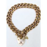 A 9ct gold curb link bracelet with patterned and plain links to heart padlock, total approx weight