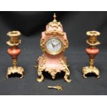 A pink marble and gilt-metal mounted clock garniture, in the French Rococo "style," comprising