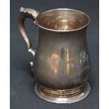 A George III silver tankard, hallmarked London 1778, of baluster form with acanthus capped