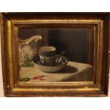 19th century English School, still life of a blue and white cup and saucer, monogrammed AT. Oil on