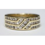 An 14k wide band three row ring channel set with thirty eight diamonds weighing a total of 0.70