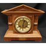 An early 20th century oak-cased mantel clock, of classical temple form, with eight-day movement by