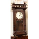 An early 20th Century wall clock with silvered dial and striking and chiming movement in glazed