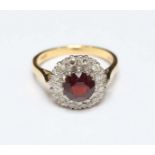 An 18ct gold, garnet and diamond cluster ring. 4.6 grams.