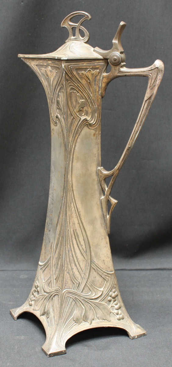 A WMF lidded ewer in and Art Nouveau style, with stylized whiplash foliate decoration, mark to base,
