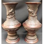 A pair of 19th century Chinese bronze vases, of baluster form, ruyi-shaped reserves cast with