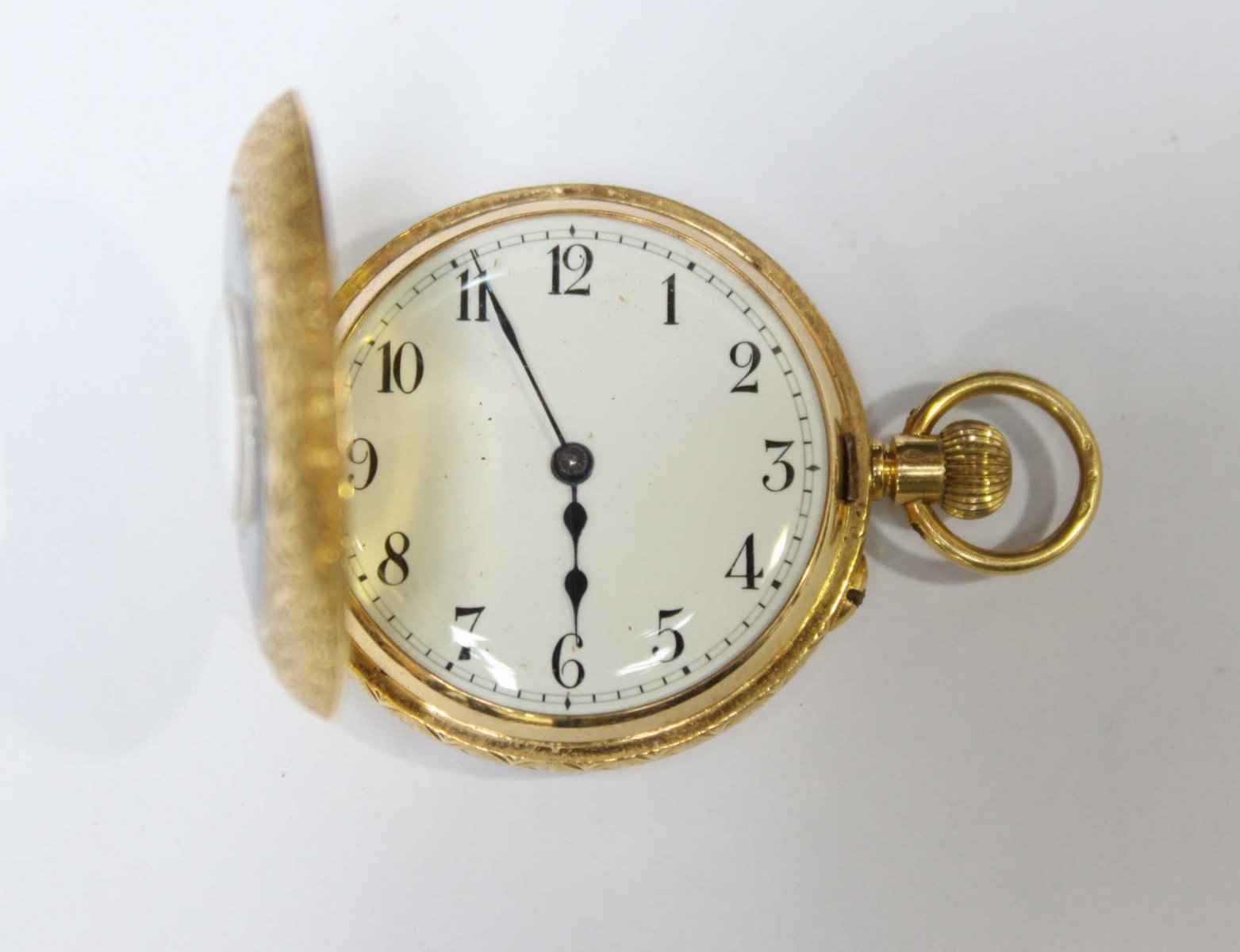 An 18ct gold engraved fob watch with blue enamelling to the face.