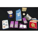 A collection of collectors proof coins, together with a collection of circulated coins and notes.