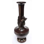 A Chinese patinated bronze small spill vase of baluster form with applied dragon around the neck,