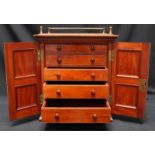 A Victorian mahogany collector’s cabinet with concealed locking mechanism, with panelled doors and