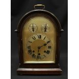 An early 20th century oak cased mantle clock, the silvered dial with separate chapter ring and