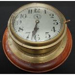 A ships brass bulkhead clock, by Bull of Bedford, with silvered dial and Arabic numerals, glass