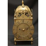 A brass lantern clock with twin fusee movement, bell and three-quarter gallery top, the dial