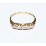 An 18ct gold and diamond five stone ring, set in platinum, with central stone weighing approx. 0.