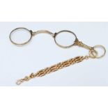 A 15ct gold lorgnette (gross weight 22.3 grams) attached to a 14ct gold three bar gate style