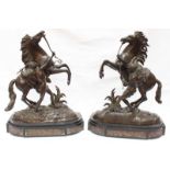 After Guillaume Cousteau.  A pair of Victorian bronze Marley horses and attendants, supported on