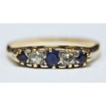 An 18ct gold five stone ring, the carved mount, claw set with three sapphires and two diamonds,