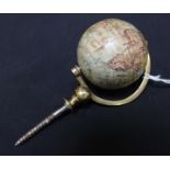 A late 19th century French miniature terrestrial globe by J.L & Co, Paris, paper overlaid and