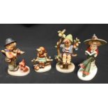 A group of four Hummel porcelain figures including 'Nasha' a girl in a broad hat seated and