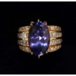 A 14K gold, tanzanite and diamond ring, set with large oval tanzanite weighing approximately 15.