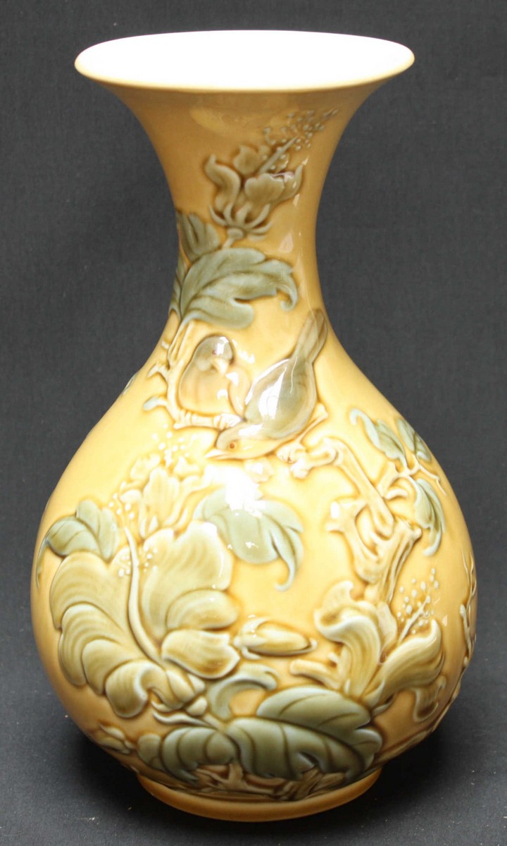 A Lladro porcelain baluster vase, moulded in relief with birds amidst branches, leaves and