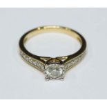 An 18ct gold solitaire diamond ring illusion set with a round brilliant cut diamond and claw set