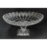 A large cut crystal tazza, finely cut with flowers and supported on a faceted stem to square stepped