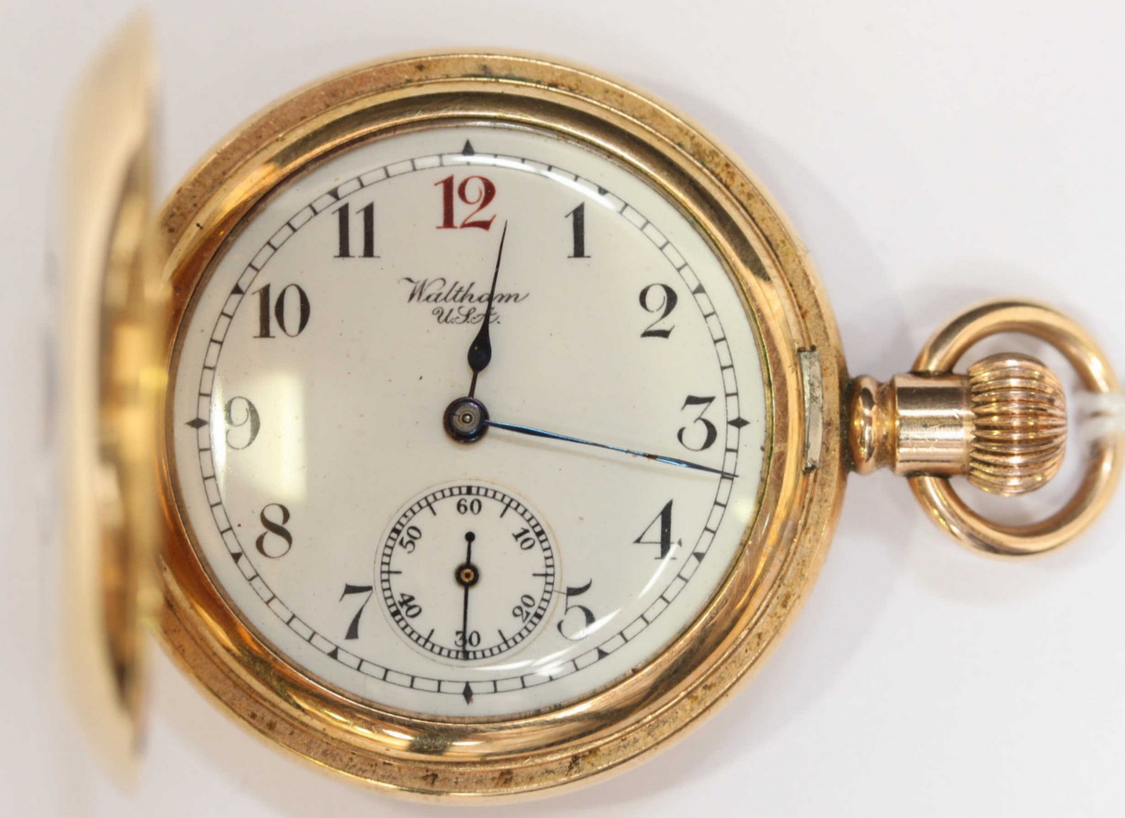 An early 20th Century gold-plated 'Waltham' ladies half-hunter pocket watch, with white dial, Arabic