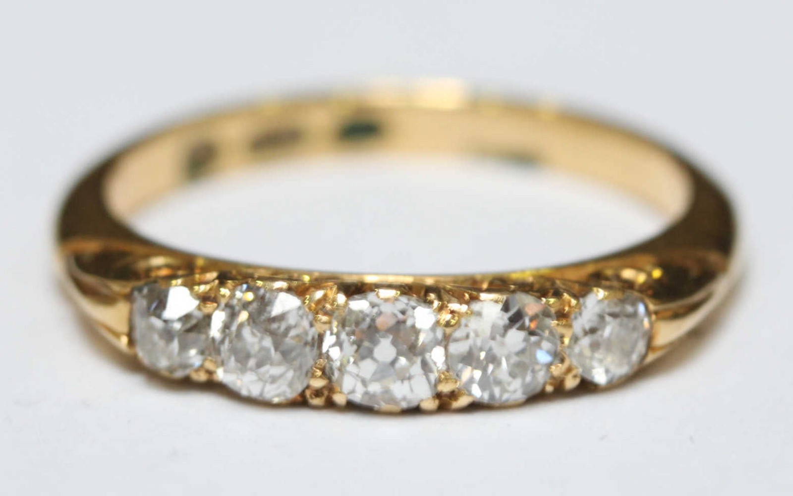 An 18ct gold and diamond five stone ring, set with larger central diamond flanked either side by