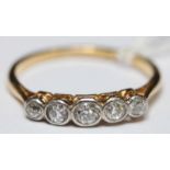 An 18ct gold and diamond five stone ring, with central stone weighing approx. 0.08cts, flanked