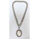 A large oval silver locket, patterned back and front, on a silver collaret, hallmarked 1882,